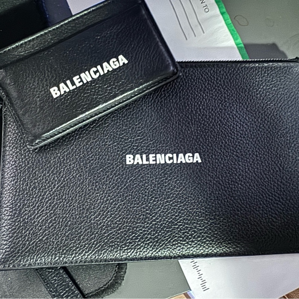 Black balenciaga mini clutch with a card holder.